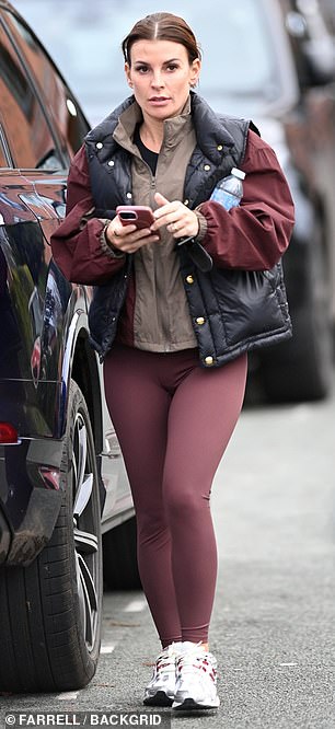 Coleen showed off her amazing physique in plum leggings and a black puffer jacket.