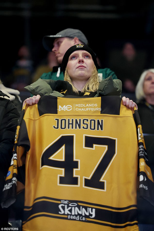 The American athlete's death stunned ice hockey fans around the world. His number '47' jersey has since been retired by his former team, as a tribute (pictured is a fan holding his shirt)