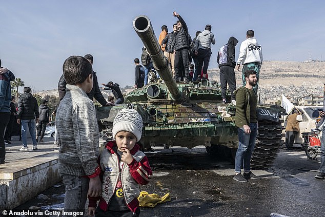 People celebrate the collapse of 61 years of Baath Party rule as they gather in Umayyad Square after armed groups opposing the Syrian regime of Bashar al-Assad took control in Damascus, Syria, December 9, 2024 .