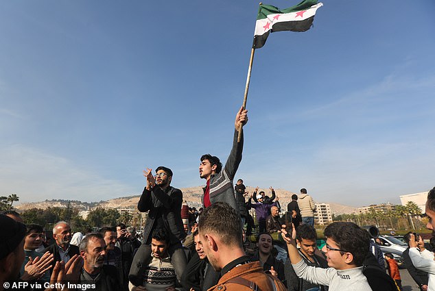 People in Damascus celebrate December 9, 2024, after Islamist-led rebels declared they had taken the Syrian capital in a lightning offensive.