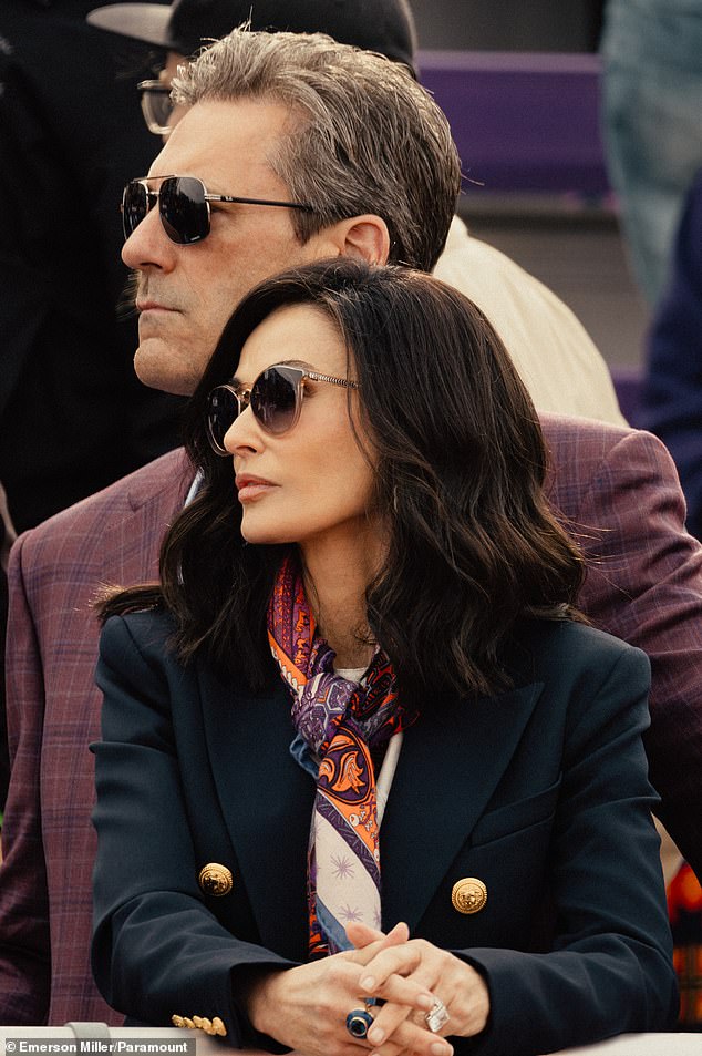 Moore is also seen wearing a jacket and her hair beautifully styled as she watches her daughter win a sprint; Hamm is also seen, but is distracted by a work call.