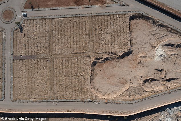 An aerial view of the mass grave as teams work to excavate the bodies of civilians.