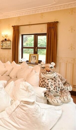 He even has a stuffed leopard sitting on the couch.