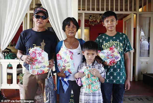 The Veloso family, including their two young children.