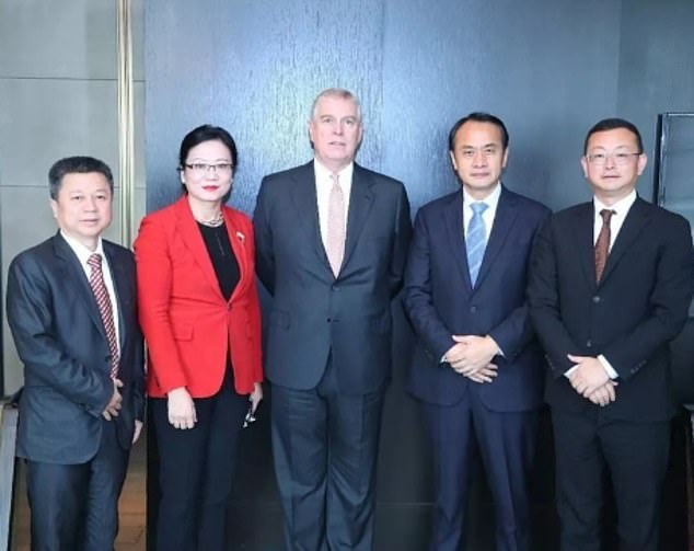 Tengbo (far right) posing with Andrew at an event to promote trade between China and Britain.