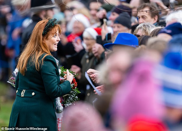 She seemed in high spirits as she laughed and joked with a crowd of onlookers lining the streets outside St. Mary Magdalene Church.