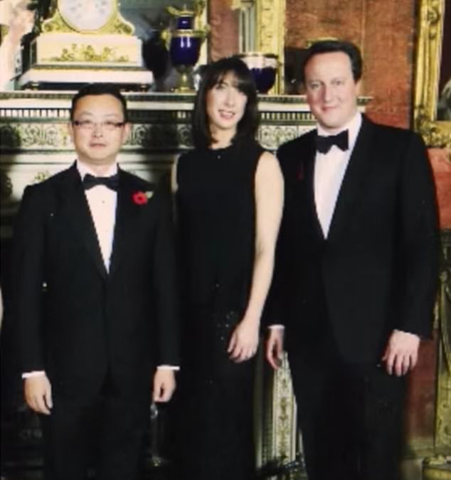 The alleged spy with former Prime Minister David Cameron and his wife, Samantha