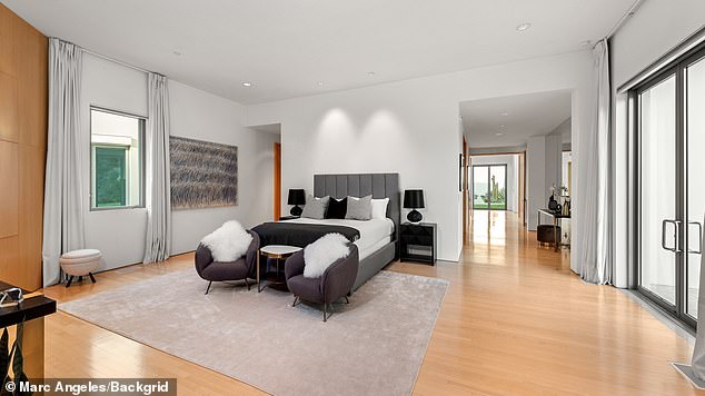 Another bedroom features gray furniture and wooden floors