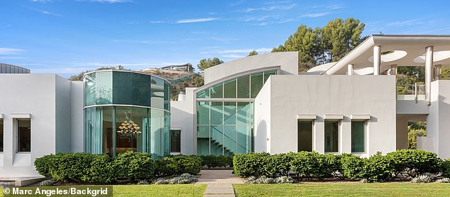 Sunlight streams into the house through the enormous windows