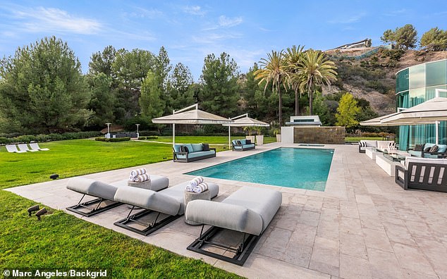 The house is surrounded by trees for privacy