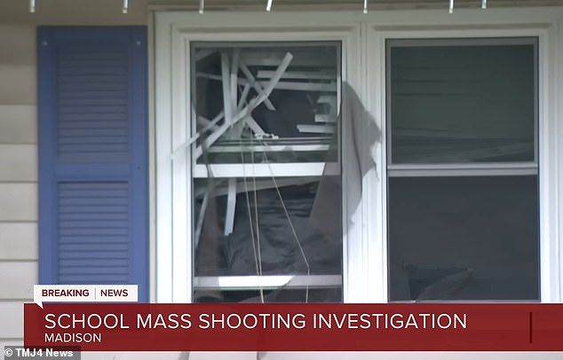 The gunman's home was raided by SWAT teams on Monday. In the photo: a broken window in the building