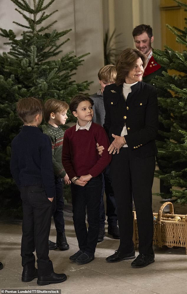 The royal, 80, received the evergreen trees at the Royal Palace in Stockholm from the Forestry University student union. From left to right: Prince Oscar, Prince Gabriel and Prince Alexander, whom Queen Silvia affectionately embraced