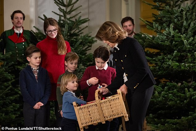 Prince Julian, Silvia's youngest grandson, is known for being a bit naughty at royal events, but seemed to be on his best behavior in a bid to get on Santa's nice list. Here he can be seen examining the brilliant decorations on Queen Silvia's basket.