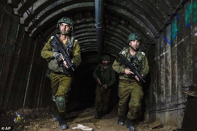 Israeli soldiers are seen in a tunnel that the army says Hamas militants used to attack the Erez border crossing in the northern Gaza Strip, on December 15, 2023