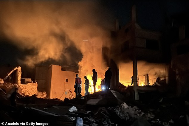 Smoke and flames rise from the al-Tabatibi family home near Palestine Square in Gaza City