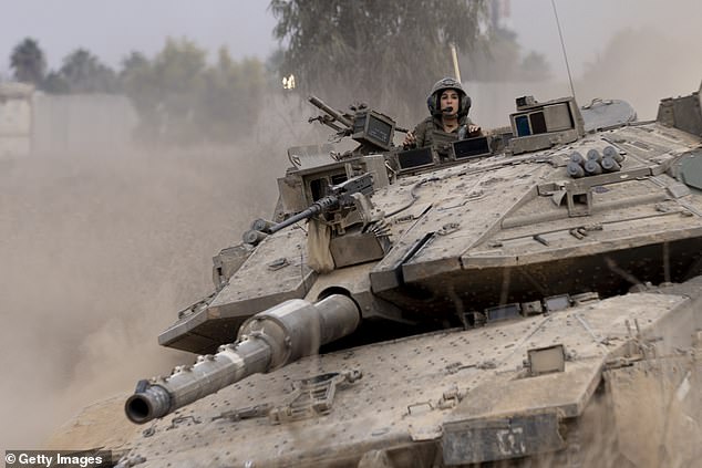 An Israeli tank approaches the border with the Gaza Strip