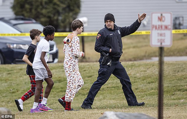 Police lead students after the shooting at Abundant Life Christian School in Madison on Monday