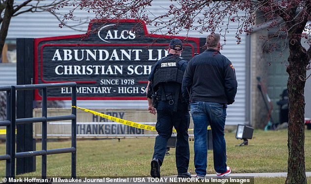 Law enforcement officers stand at the scene of Monday's shooting that left three dead, including the shooter