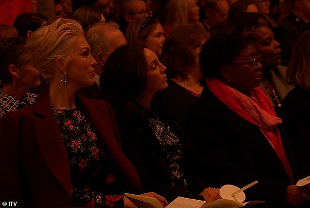 As she performs the Christmas hymn, written by Noël Regney and Gloria Shayne in 1962 as a plea to end the Cuban missile crisis, the camera pans to show an audience absorbed in her performance.