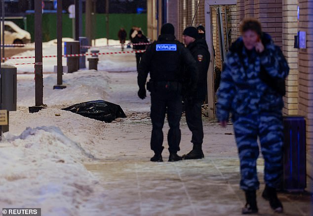 Russian police can be seen setting up a cordon around the body bags after the explosion.