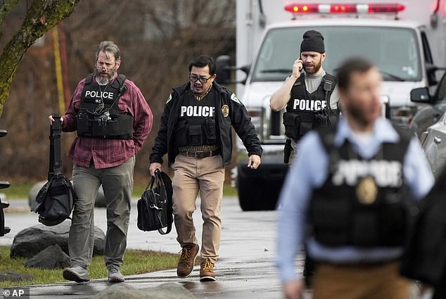 Police walk outside Abundant Life Christian School after the shooting