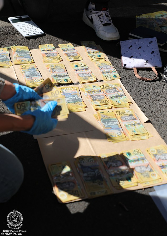 Police confiscated a large amount of cash following the arrests (pictured)