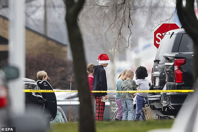 Children are led away from the murder scene in an attempt to reunite with their parents. All surviving students were eventually returned to their families