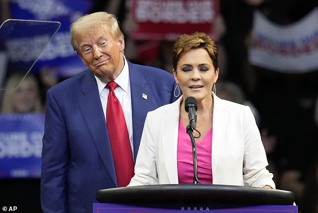 Republican presidential candidate, former President Donald Trump, listens as Arizona Senate candidate Kari Lake speaks during a campaign rally at the Findlay Toyota Arena on Sunday, Oct. 13, 2024, in Prescott Valley, Ariz.