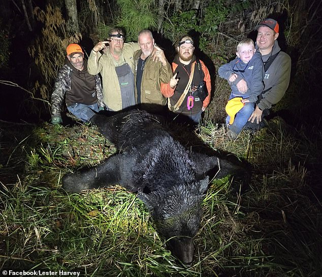 The hunter's funeral is scheduled for December 19, according to his obituary. He is survived by his wife, April McAllister Harvey, his five children and eight grandchildren. In the photo: Lester Harvey (center) with his family and his prey.