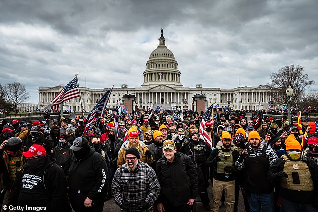 Pro-Trump protesters, including Proud Boys leader Joe Biggs, (checkered shirt in bottom center of frame) gather in front of the U.S. Capitol on January 6, 2021