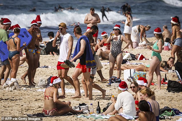 Fortunately, Australians will have a respite from the scorching heatwave conditions suffered over recent weeks (pictured, Christmas revelers on Bondi Beach in 2022)