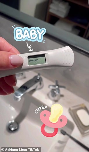 A closer look: He holds the test over a sink while adding a pacifier with the word 