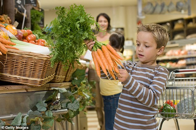 Farmer Christmas has personally delivered more than 29 tonnes of twisted carrots on his festive tractor for children to collect for free, ready to keep on Christmas Eve (file image)