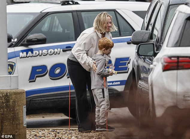 People are seen at a reunification center after a shooting at Abundant Life Christian School in Madison