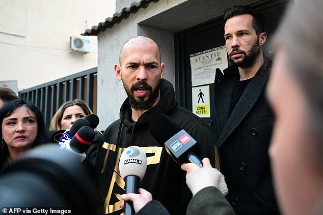 Andrew (C) and his brother Tristan (behind) speak to journalists after being released from detention in Bucharest, Romania, on March 12, 2024.