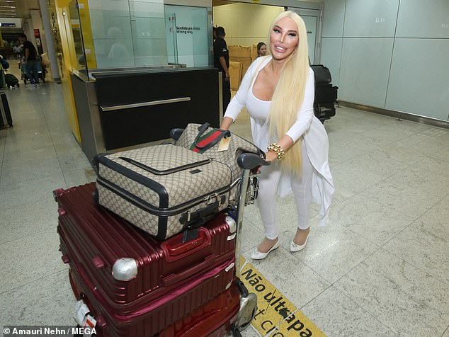 Jessica seemed in good spirits as she walked through the arrivals terminal with her two large red suitcases and two Gucci carry-on suitcases.