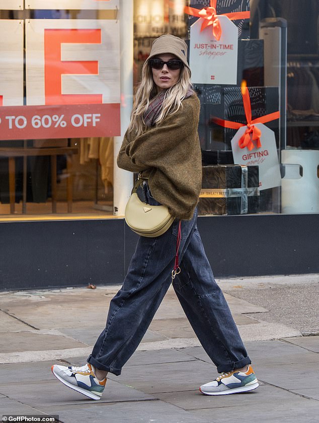 The actress looked incredibly stylish in a khaki Adidas bucket hat and a pale green Prada crossbody bag.