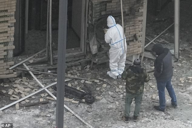 Investigators work near a scooter at the site where Lieutenant General Igor Kirillov, head of Russia's Nuclear, Biological and Chemical Defense Forces, and his assistant Ilya Polikarpov were killed by an explosive device.