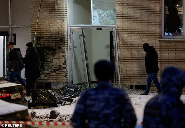 Two body bags can be seen after bomb was detonated outside Moscow apartment