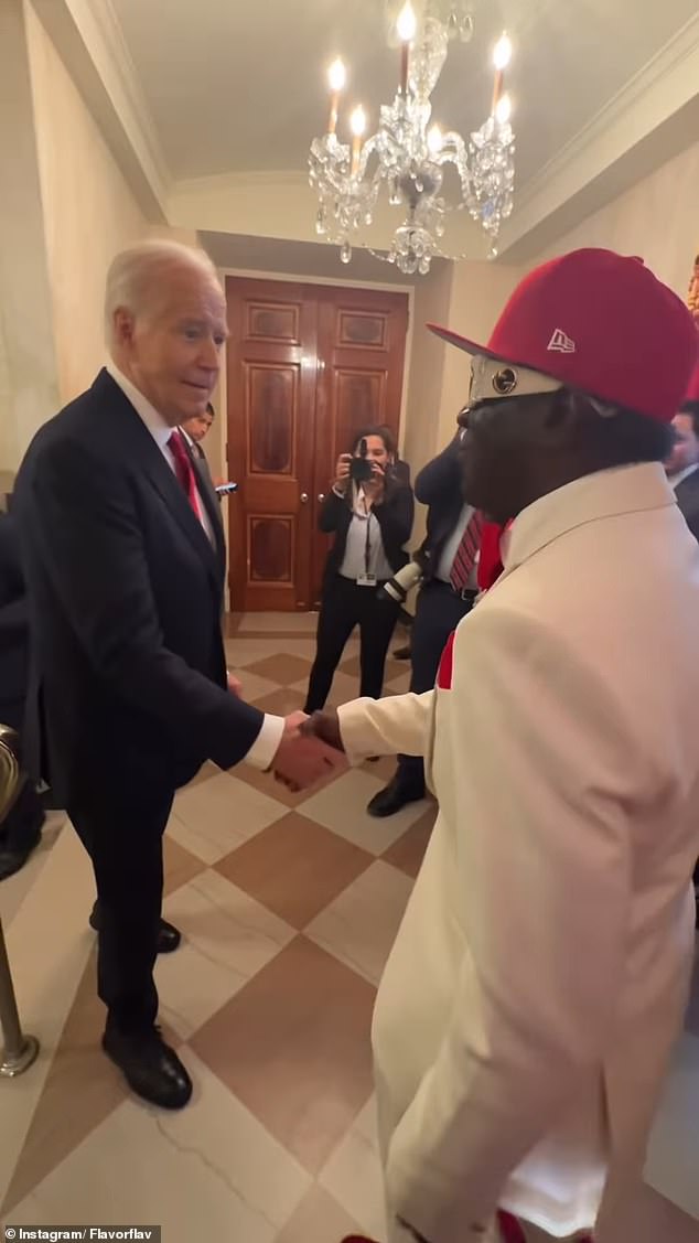 President Joe Biden shakes hands with Flavor Flav