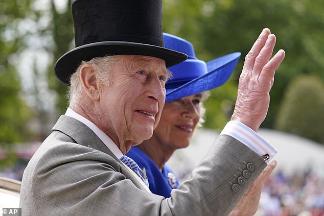 King Charles III and Queen Camilla wave as they arrive by carriage on the first day of the Royal Ascot horse race at Ascot.