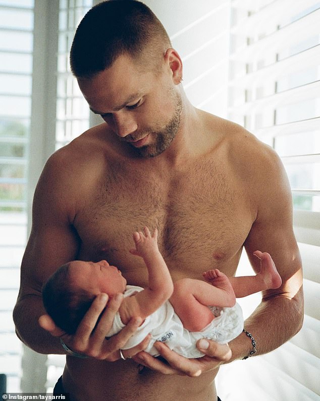 In one image, the Greater Western Sydney Giants footballer looked every inch the doting father as he cradled the little one in his arms.