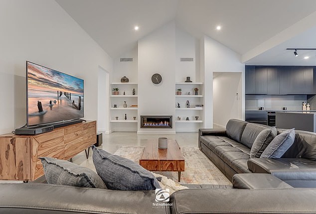 Located 65km from the CBD, the custom-built pad features a swimming pool, media room and home office. In the photo: one of several living rooms.