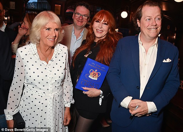 Pictured: (LR) Queen Camilla, Ewan Venters, Charlotte Tilbury and Tom Parker Bowles attend the launch of Tom Parker Bowles' new book Cooking & The Crown at The Audley Public House in September 2024 in London.