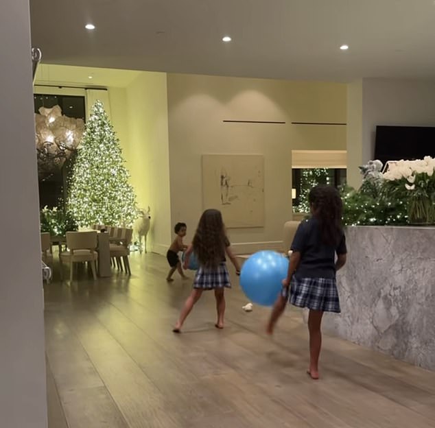 Khloe also posted an adorable moment with her children True, six, and Tatum, two, with their cousin Dream Kardashian, eight, playing by the tree