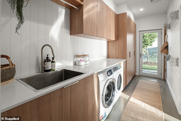 And it also serves as a laundry room. Warm tones carry through here, making it feel as luxurious as the public areas of the home.