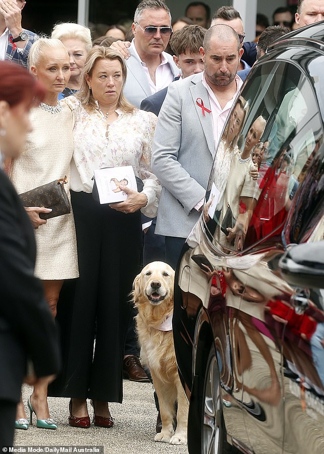 Bianca Jones' mother and father are seen alongside Holly Bowles' mother (centre) at their daughter's funeral at Mentone Girls' Grammar in Melbourne on December 6.