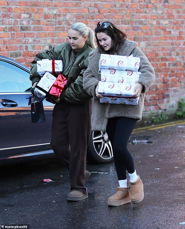 Molly opted for minimal makeup for the outing and looked sad as she carried boxes covered in Christmas wrapping and a Chanel gift bag.