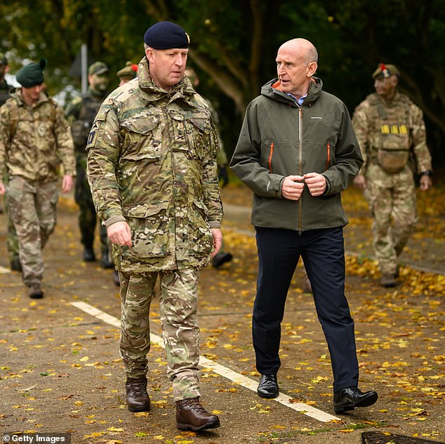 Defense Secretary John Healey (right) is set to send British troops to Ukraine to train new recruits there. He is seen speaking to British soldiers at Stanford Training Area on October 20, 2024 near Thetford, England.