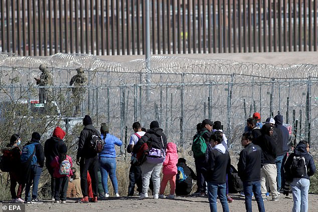 A group of migrants wait at a border point in Juarez City, Chihuahua, Mexico, December 18, 2024. On International Migrants Day, the Texas National Guard fired pepper balls to disperse a group of more than 150 migrants, mostly from Central and South America. who were tricked on social networks into thinking they would be allowed to pass through the border wall in northern Mexico